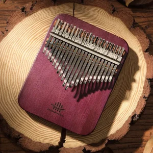 Hluru 21 Key Solid Body Kalimba in Purpleheart wood placed on a wooden log background