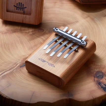 Hluru 5 key Mini Kalimba placed on wooden surface, compact kalimba for meditation and music therapy