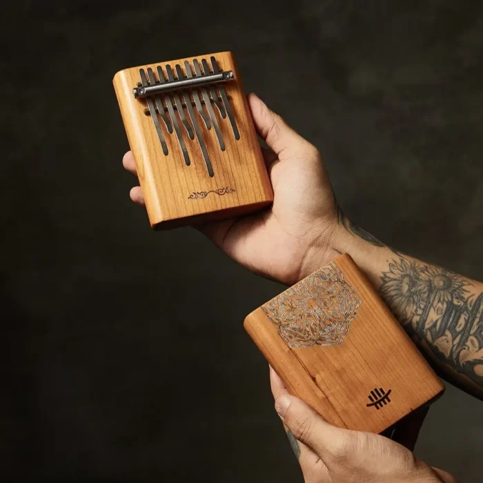 Hluru 9 key mini kalimba placed on wooden background with engraved back design