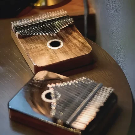 A showcase of two LOOP kalimbas, with the Acacia model in the foreground and the Rosewood model blurred in the back.
