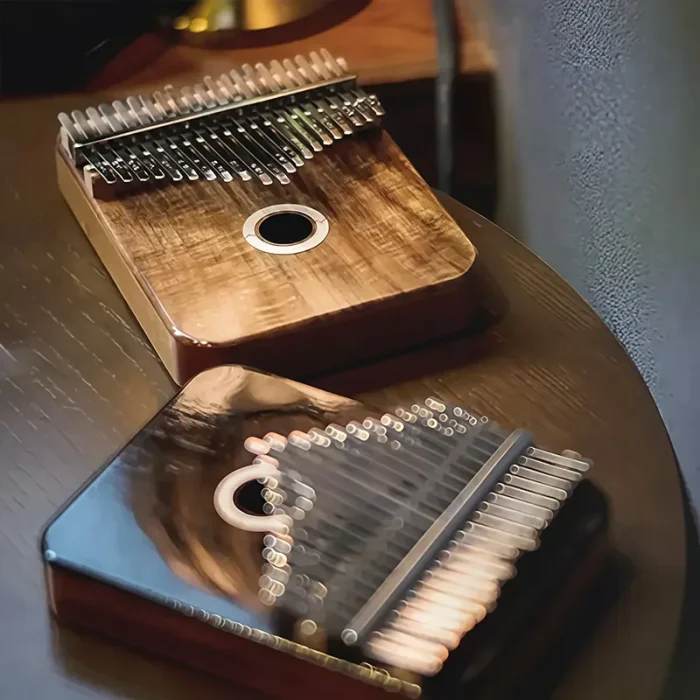 A showcase of two LOOP kalimbas, with the Acacia model in the foreground and the Rosewood model blurred in the back.