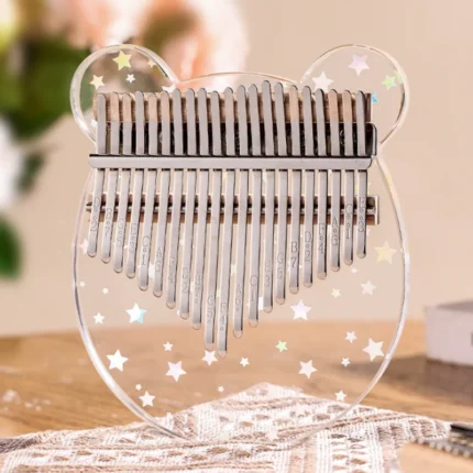 A 17-key transparent acrylic kalimba shaped like a bear, featuring star patterns from HUASHU’s Starry Series.