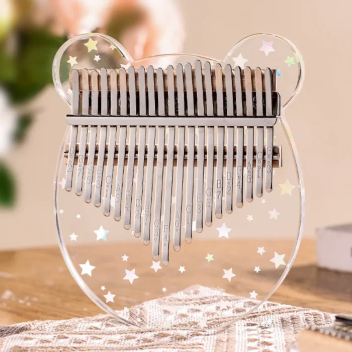 A 17-key transparent acrylic kalimba shaped like a bear, featuring star patterns from HUASHU’s Starry Series.