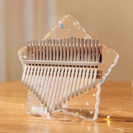 A transparent star-shaped acrylic kalimba with 17 keys and decorative stars.
